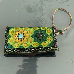 Wristlet, brand new. Embroidered with sequence work on it.